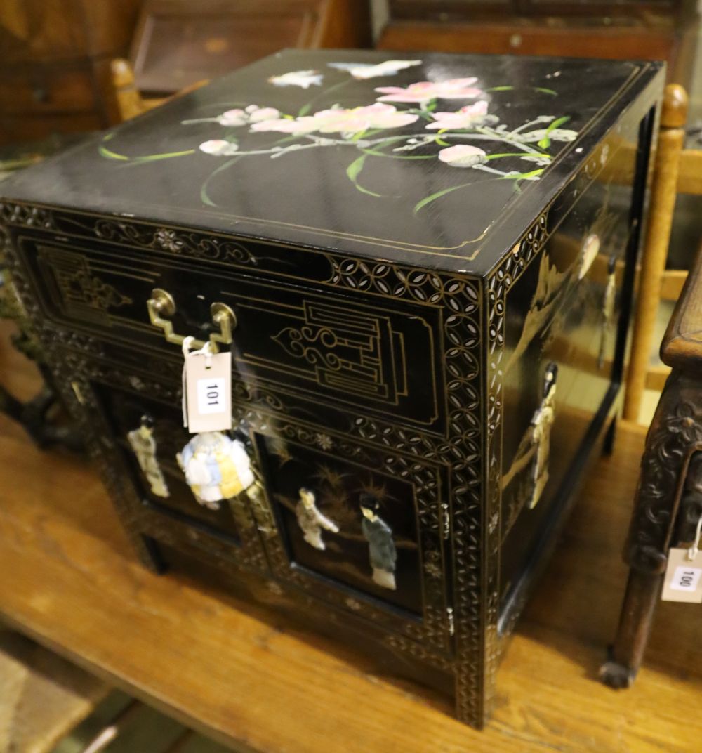 A Chinese black-lacquered brass-mounted small two-door cabinet, the door panels decorated with figures, width 51cm, depth 51cm, height